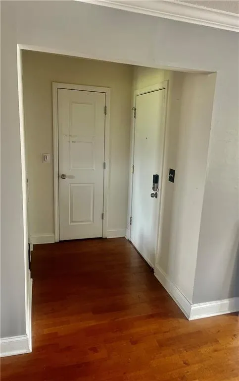 Hallway with wood finished floors and baseboards