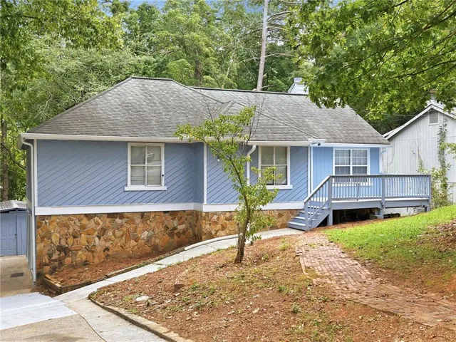 Light blue siding exterior with a partial stone facade