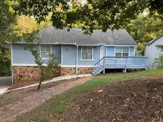 Blue siding exterior with a stone veneer foundation
