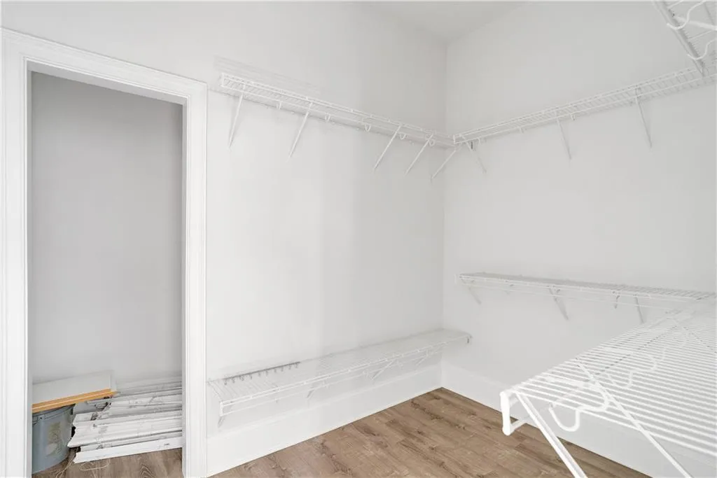 Spacious closet with wood finished floors