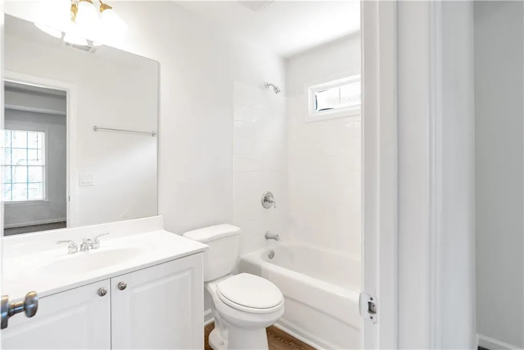Full bath with toilet, vanity, visible vents, and shower / bathing tub combination