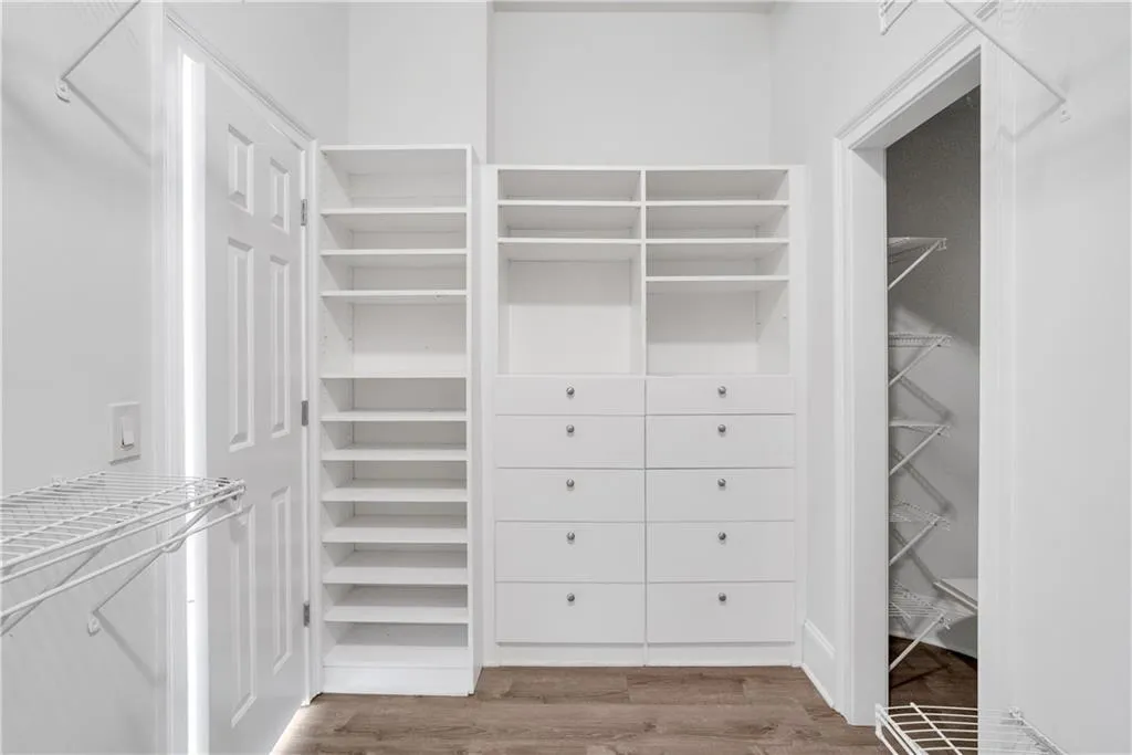 Walk in closet featuring wood finished floors