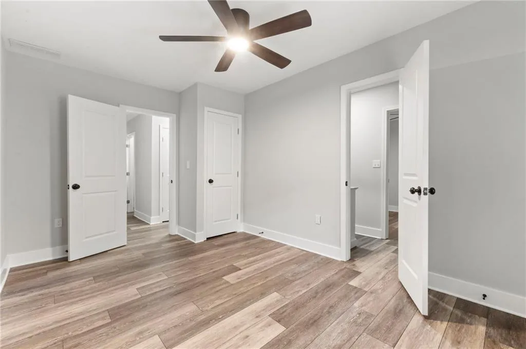 Unfurnished bedroom featuring light wood-style flooring and a ceiling fan