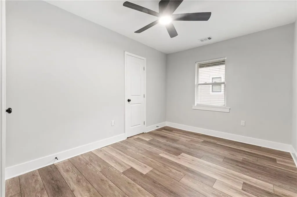 Spare room with light wood-type flooring and baseboards