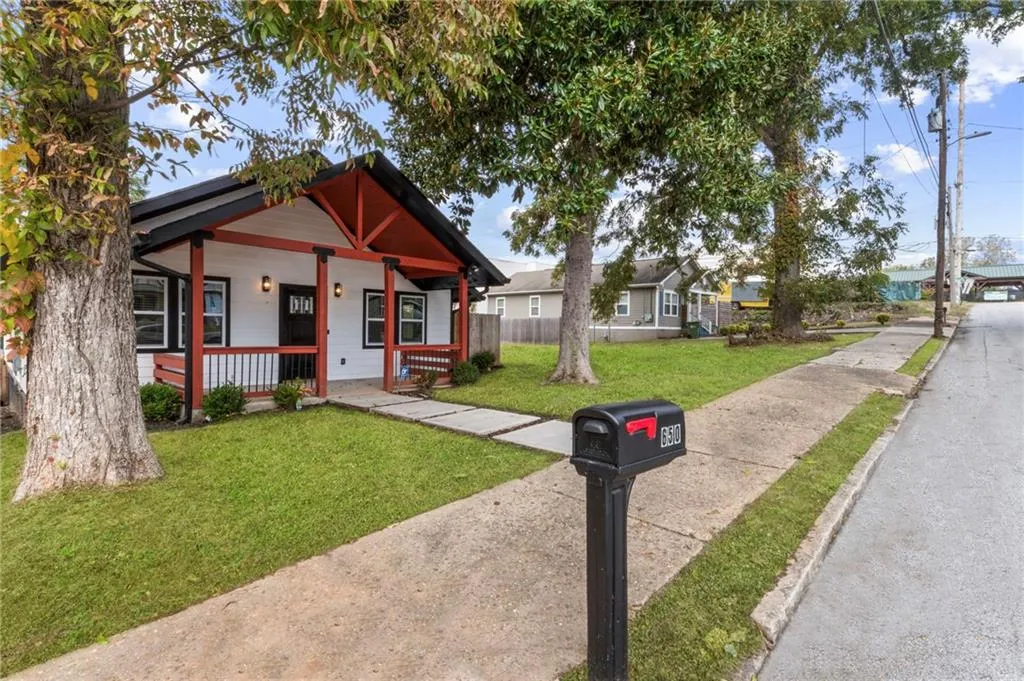 Bungalow-style home with covered porch and a front yard
