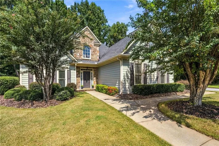 Stone and siding exterior with arched window detail