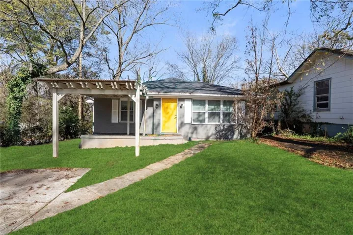 Gray exterior siding with white window trim and shutters