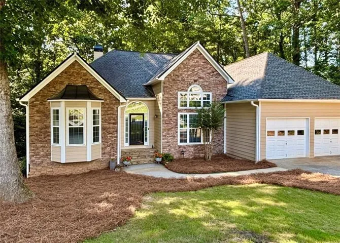 Brick and siding facade with a two-car garage