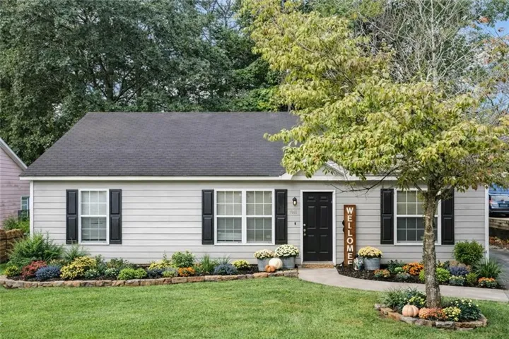 Single story home with a front lawn and roof with shingles