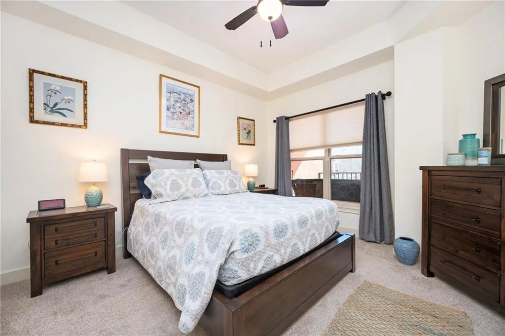 Bedroom featuring light carpet and a ceiling fan