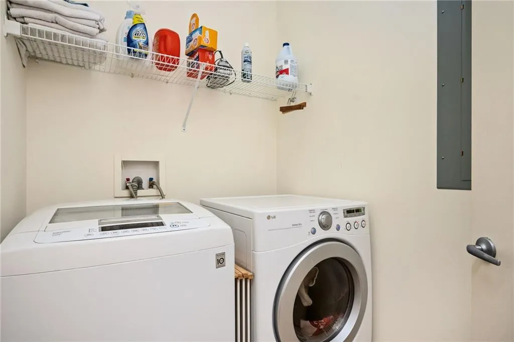 Clothes washing area with laundry area, electric panel, and independent washer and dryer