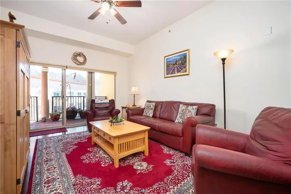 Living room featuring wood finished floors and ceiling fan