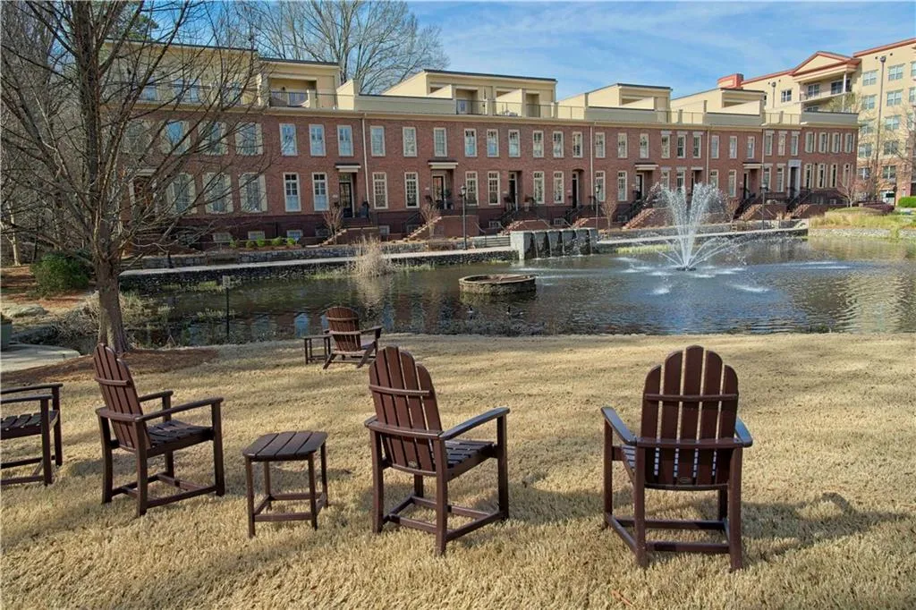 Surrounding community featuring a water view and a lawn