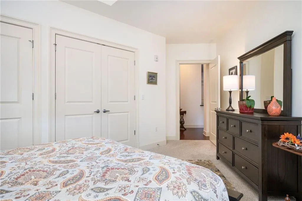 Carpeted bedroom with baseboards and a closet