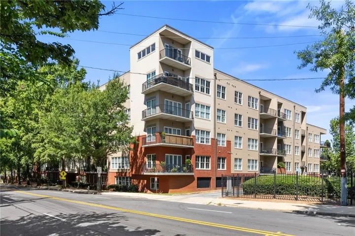Multi-story residential building featuring a stucco and brick exterior