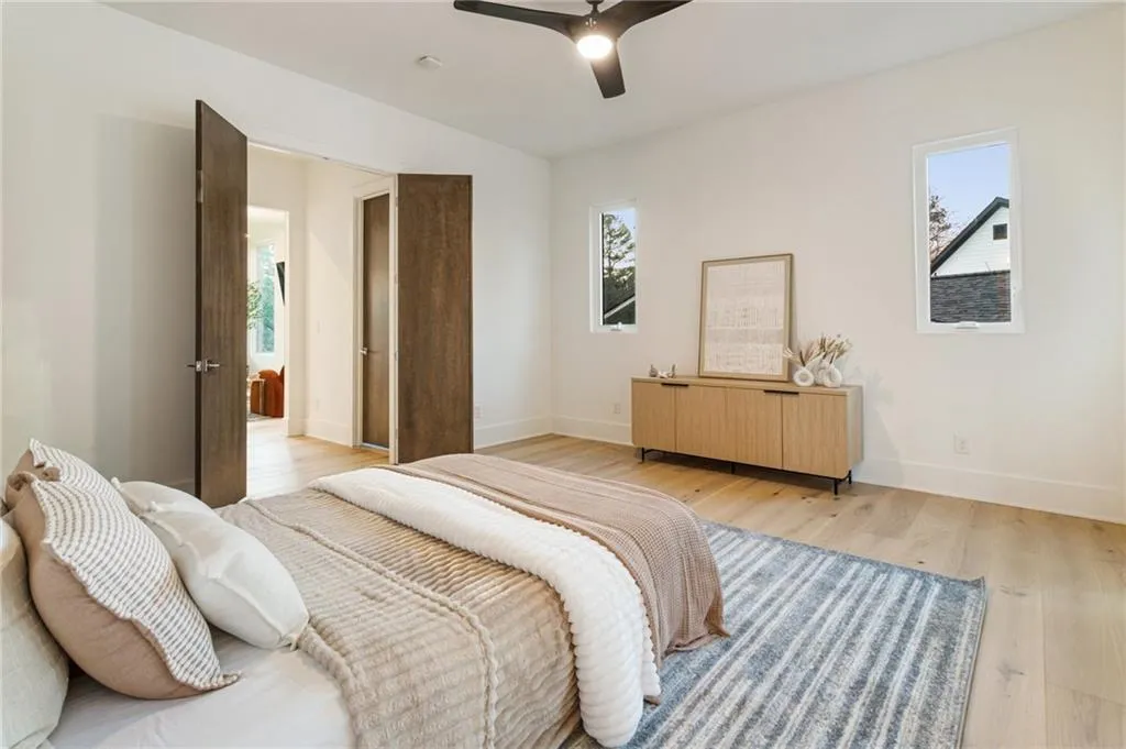 Bedroom with baseboards, light wood-style flooring, and a ceiling fan