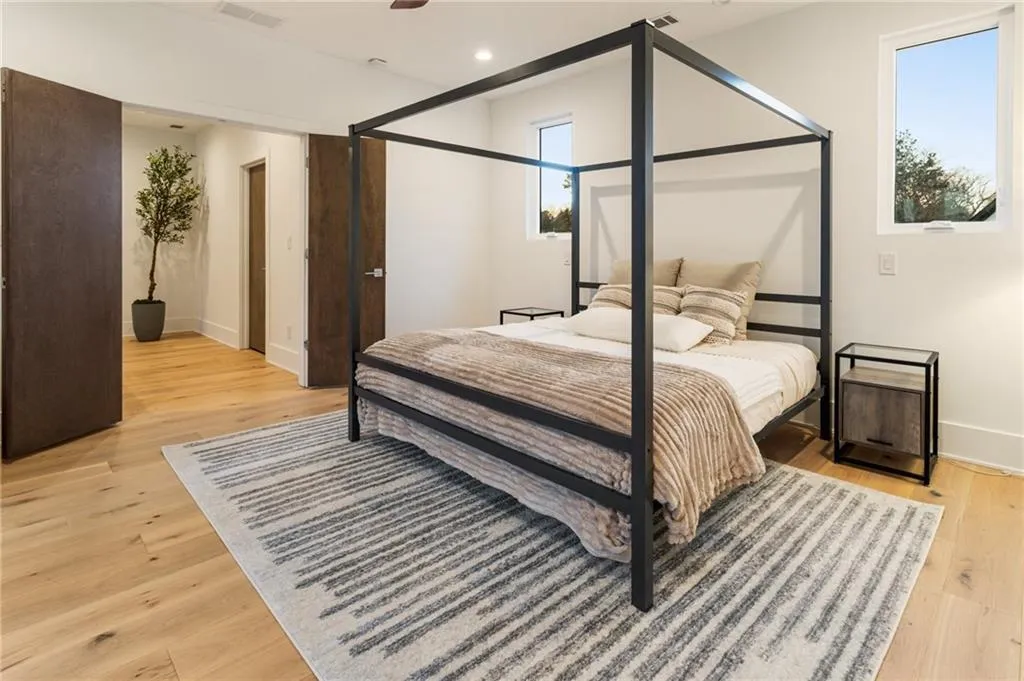 Bedroom with light wood finished floors, baseboards, and recessed lighting