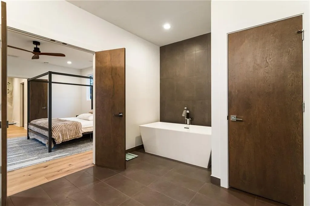 Full bathroom featuring a ceiling fan, a soaking tub, tile patterned floors, ensuite bath, and recessed lighting