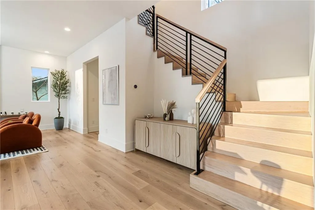 Staircase featuring wood finished floors, baseboards, and recessed lighting