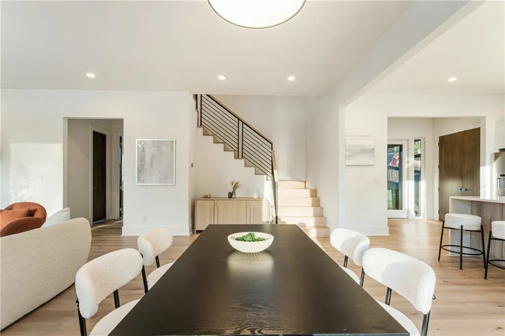 Dining space with stairway, light wood finished floors, and recessed lighting