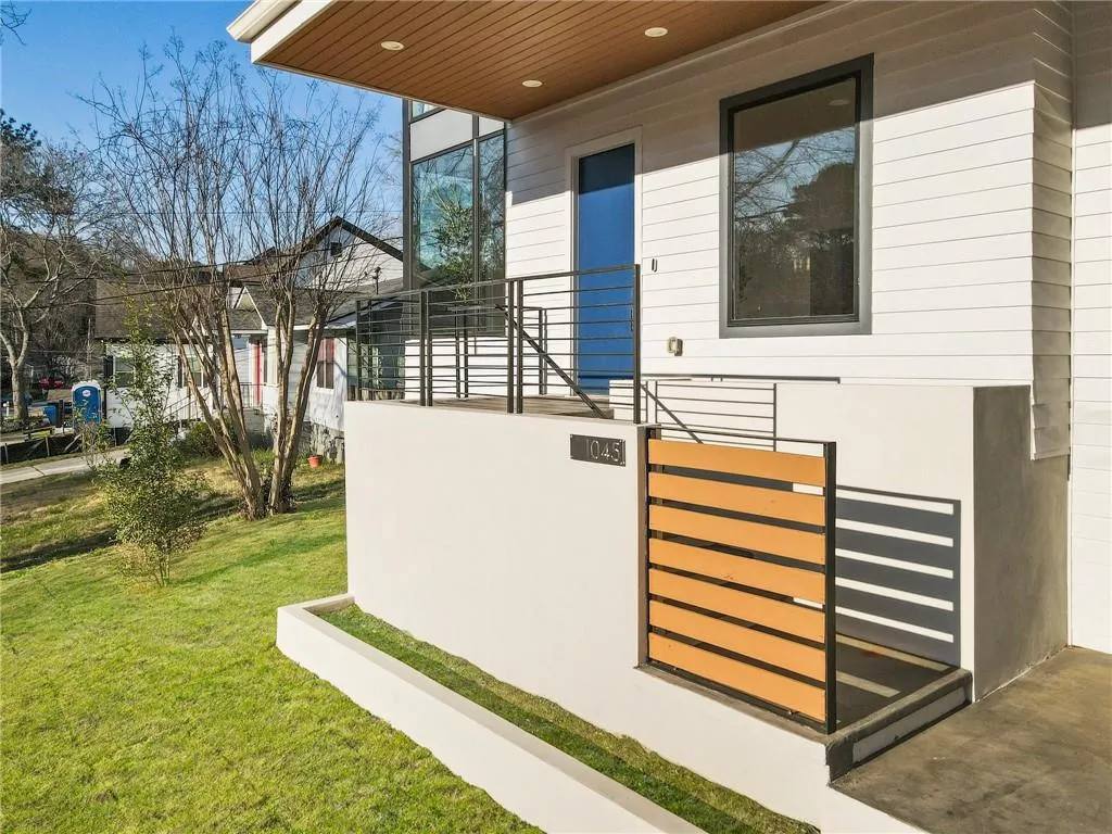 View of side of home featuring a lawn