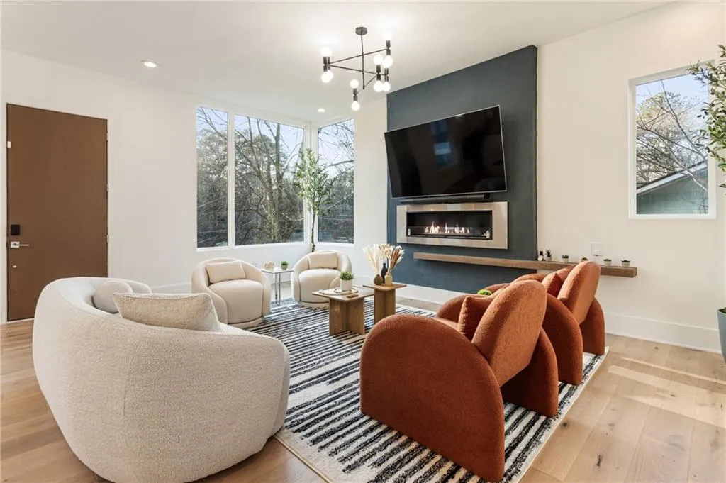 Living area featuring plenty of natural light, wood finished floors, and recessed lighting