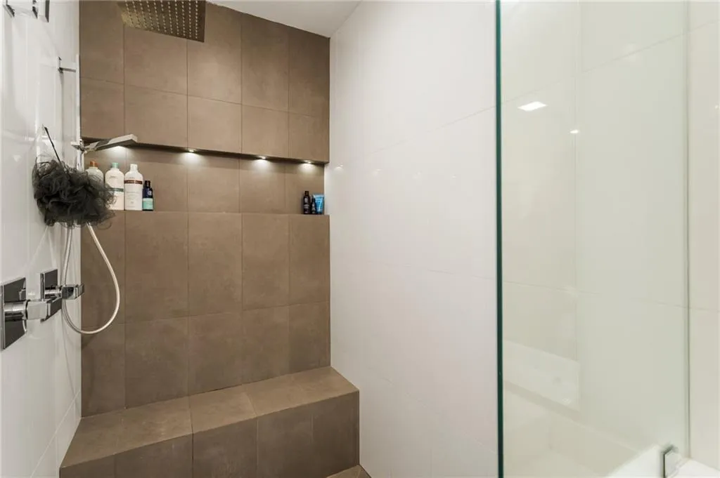 Full bath featuring a tile shower