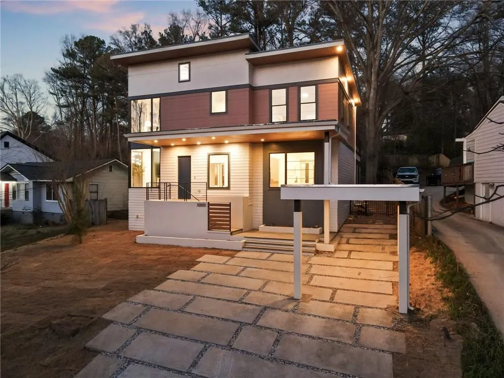 Front of property at dusk with covered porch