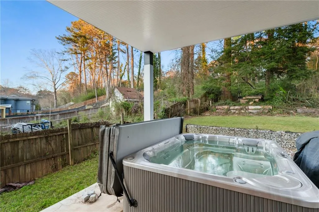 View of patio with a hot tub