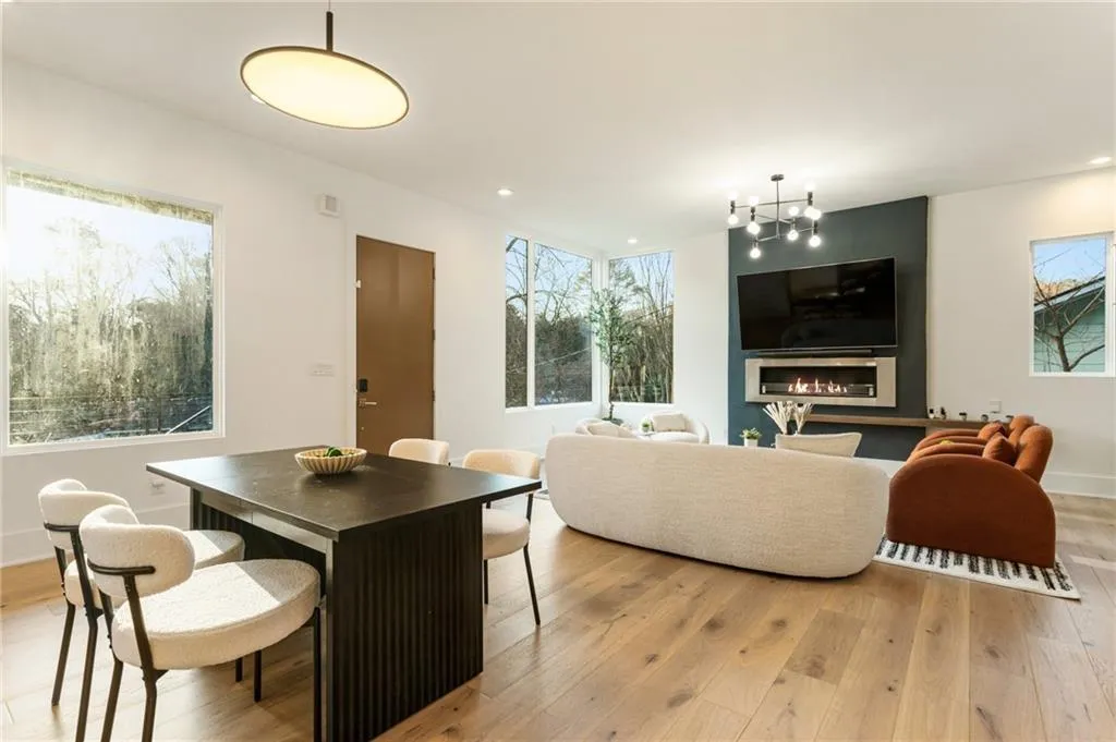 Dining area with light wood finished floors, a chandelier, recessed lighting, and baseboards