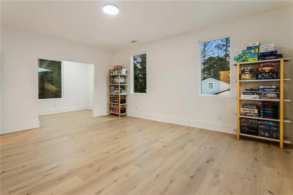 Empty room featuring hardwood / wood-style flooring and baseboards