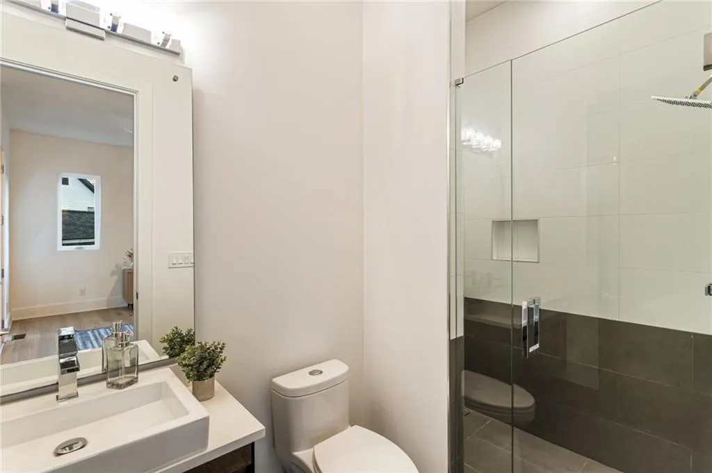 Bathroom with toilet, a shower stall, and vanity