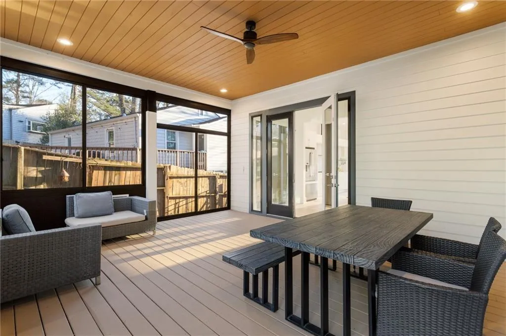 Sunroom / solarium with ceiling fan and outdoor dining area