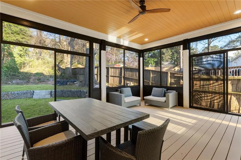 Sunroom / solarium with ceiling fan and outdoor dining space