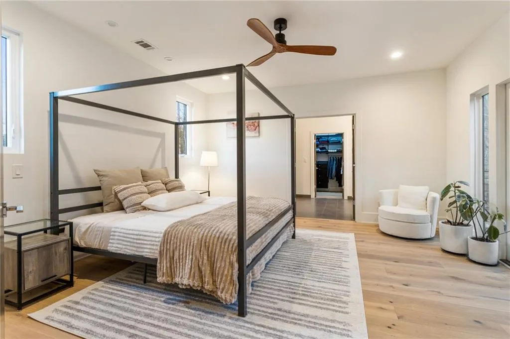 Bedroom featuring light wood-style floors, recessed lighting, a ceiling fan, and baseboards