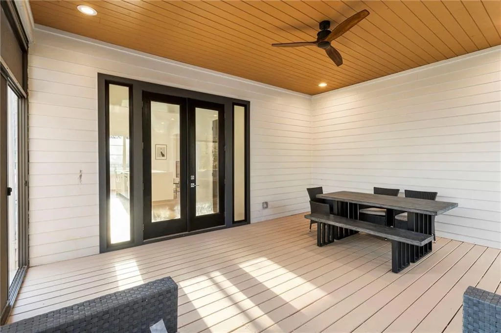 Wooden deck featuring ceiling fan and french doors