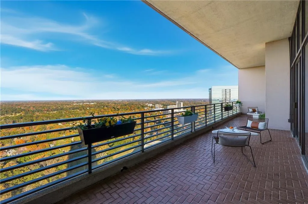 An expansive penthouse balcony that offers serene outdoor living with breathtaking, unobstructed views in every direction.