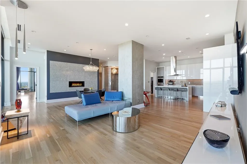 The open floor plan, framed by floor-to-ceiling windows, delivers sweeping, unobstructed views from every room.