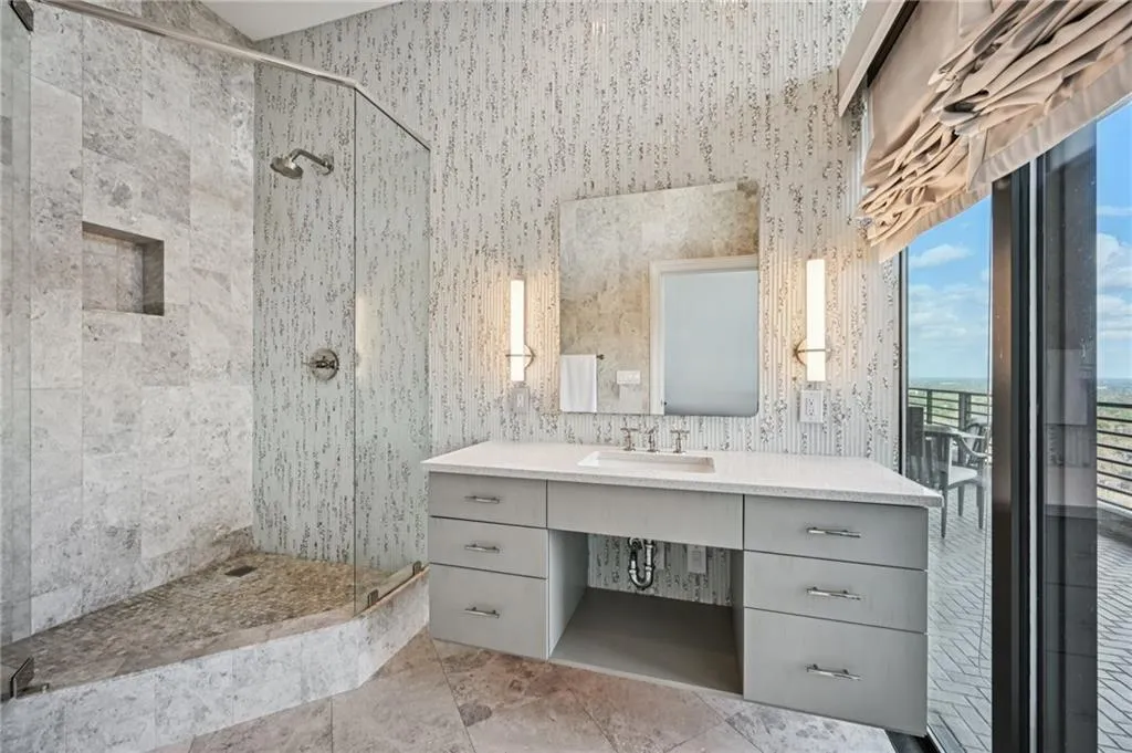 Full bath with a shower stall and vanity