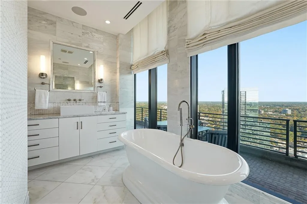 A stunning primary bath framed by floor-to-ceiling windows, offering truly breathtaking views.