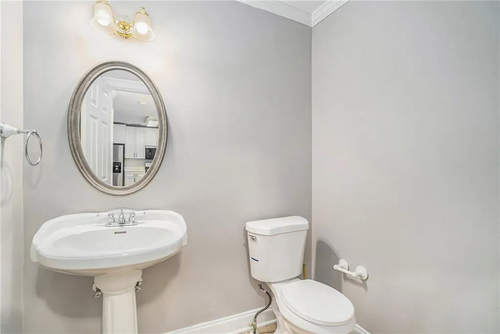 Bathroom featuring toilet and crown molding