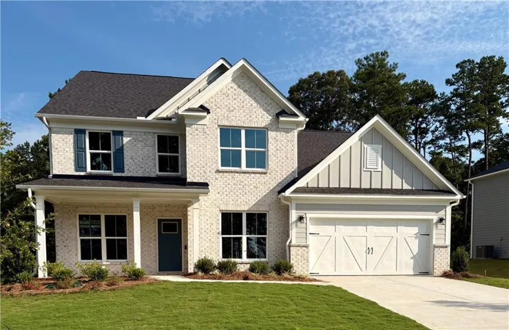 Two-story residence featuring light-colored brick and horizontal siding accents