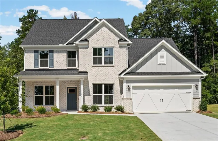 Two-story residence featuring light-colored brick and horizontal siding accents