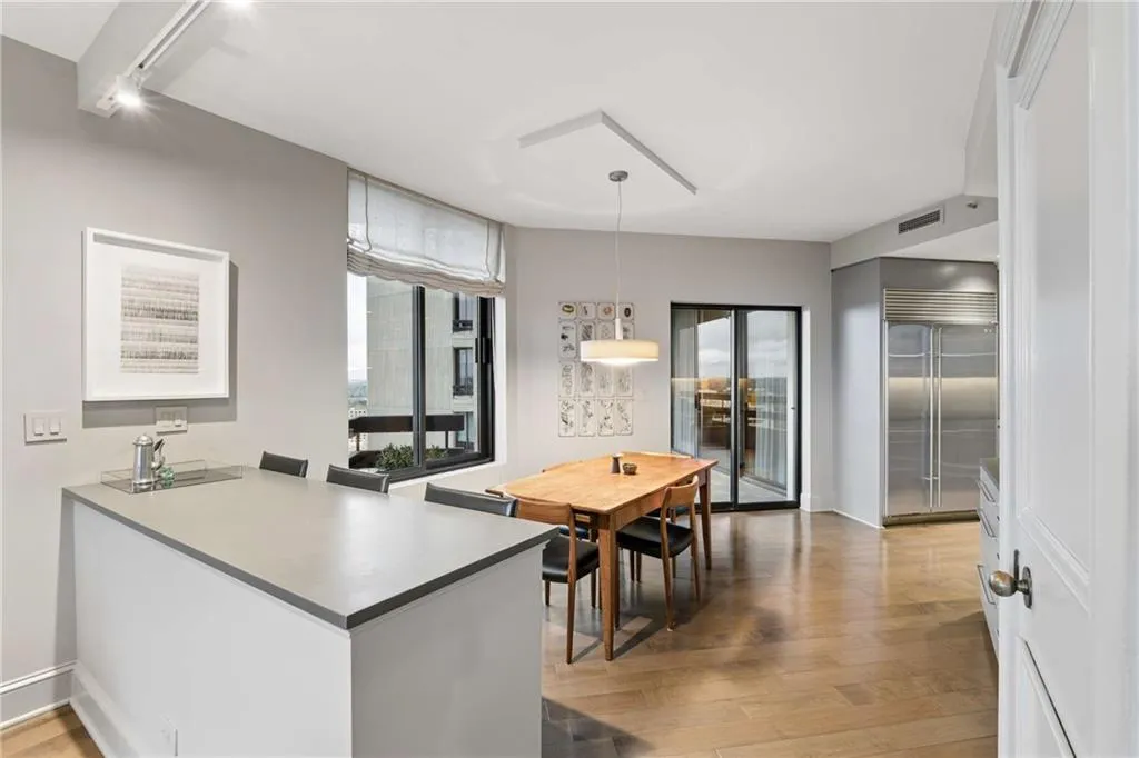 Dining room with light wood-type flooring and baseboards