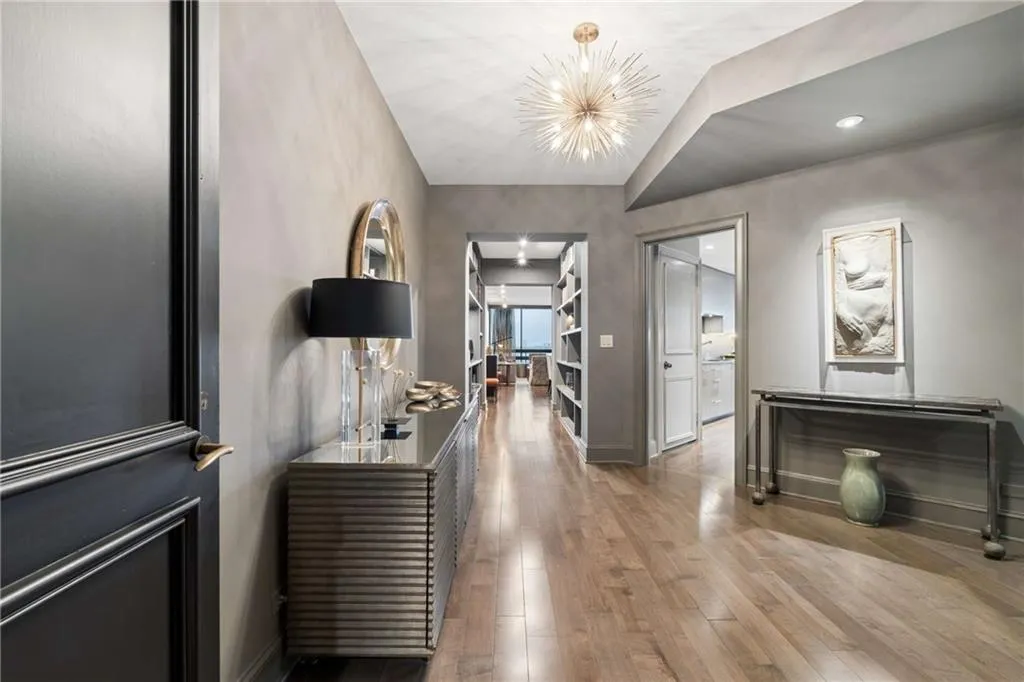 Hallway with hardwood / wood-style floors and baseboards