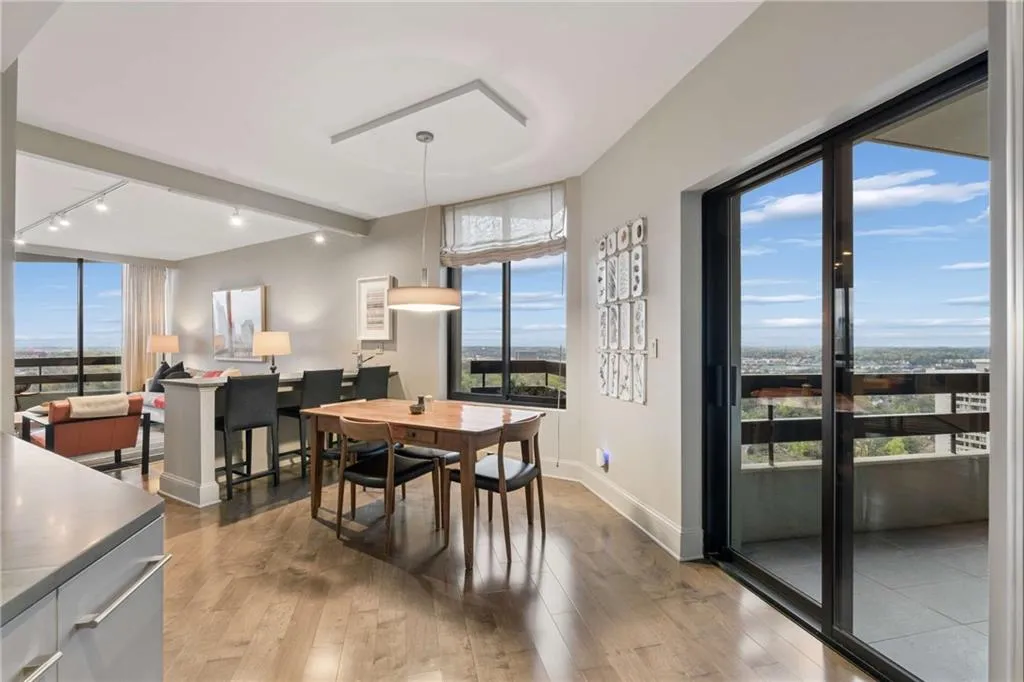 Dining space with light wood-style floors, plenty of natural light, track lighting, and beamed ceiling