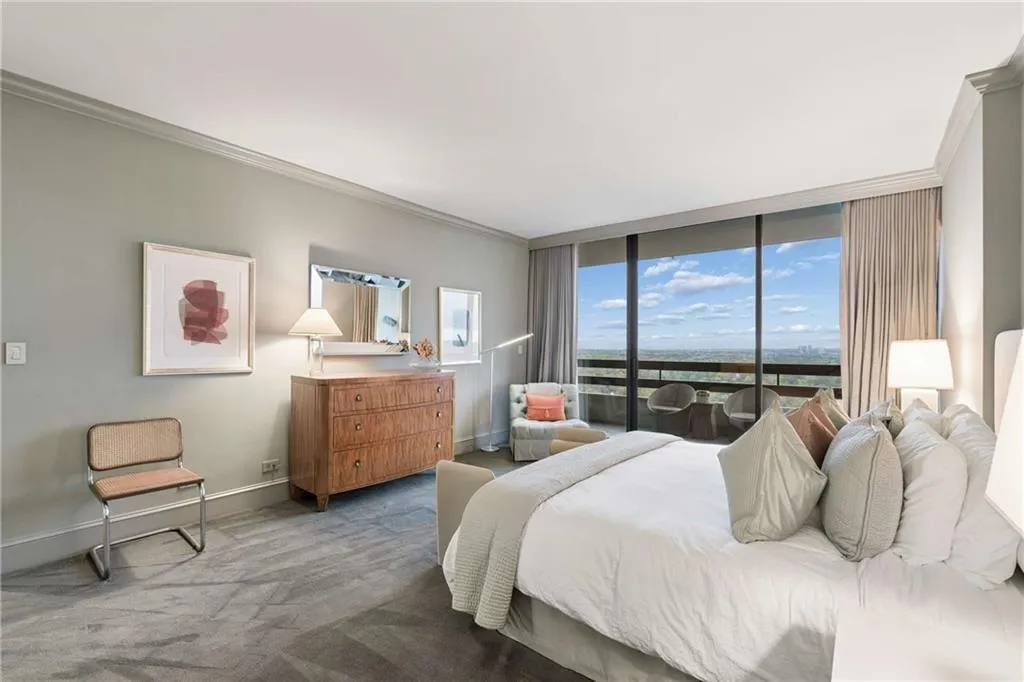 Carpeted bedroom with crown molding and baseboards