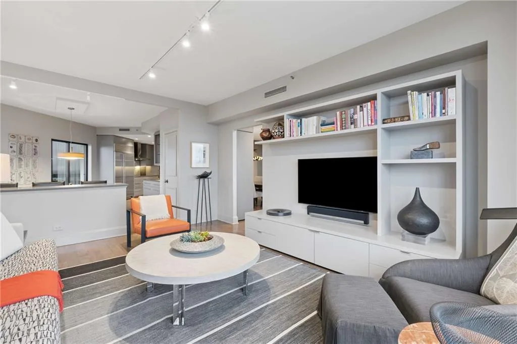 Living area featuring wood finished floors and track lighting
