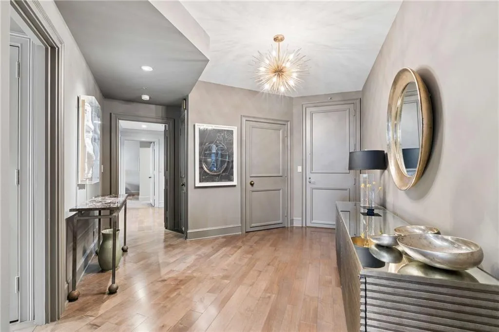 Foyer entrance with light wood-type flooring and hanging lights