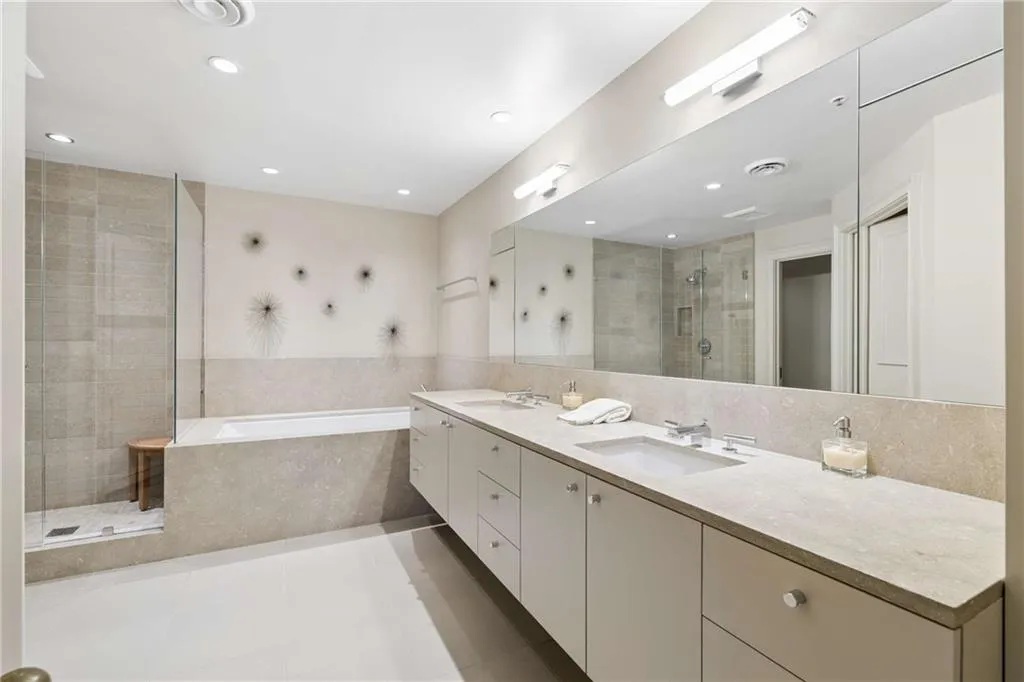 Bathroom with a stall shower, double vanity, a bath, light tile patterned floors, and recessed lighting